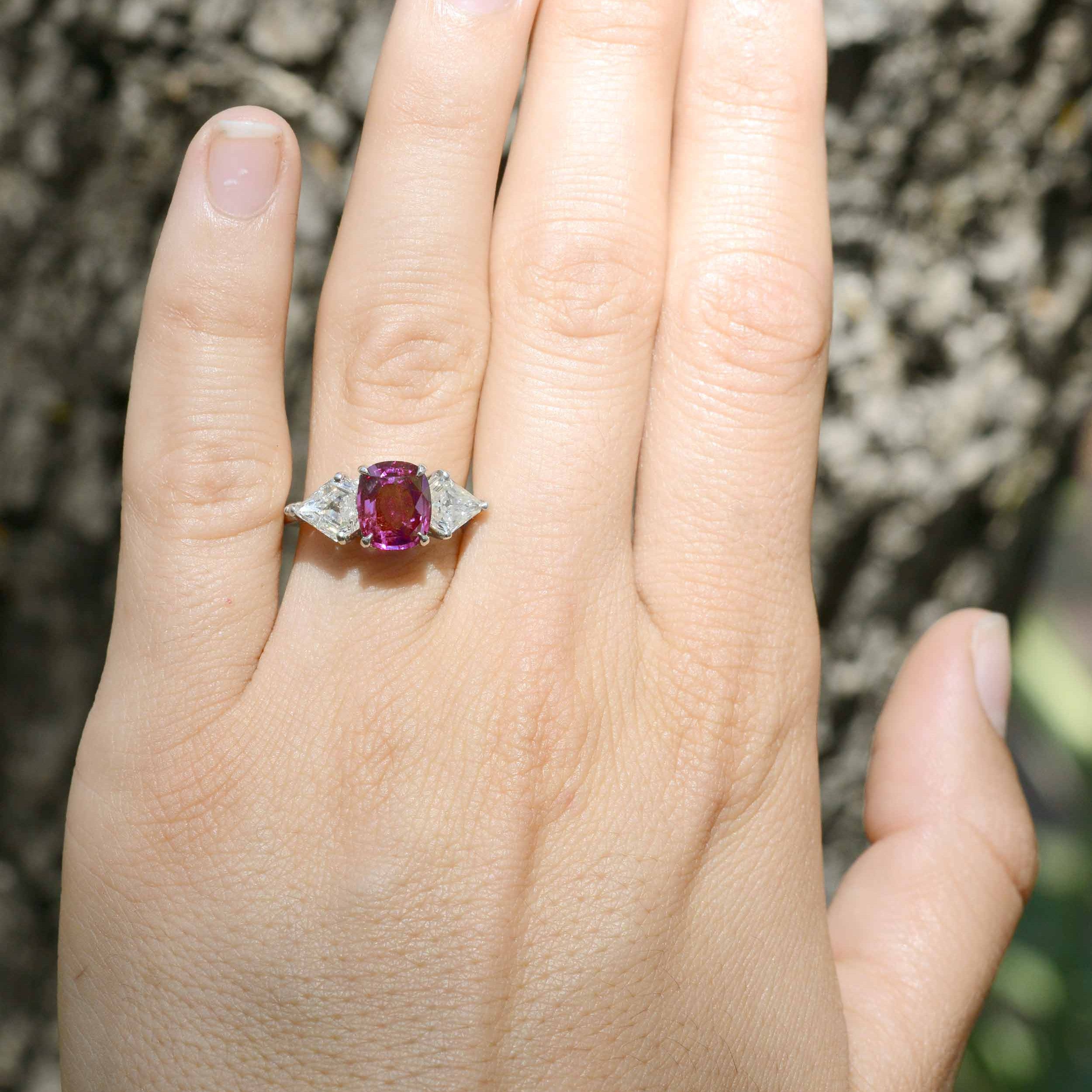 This unique, cushion cut purple pink sapphire has great transparency.