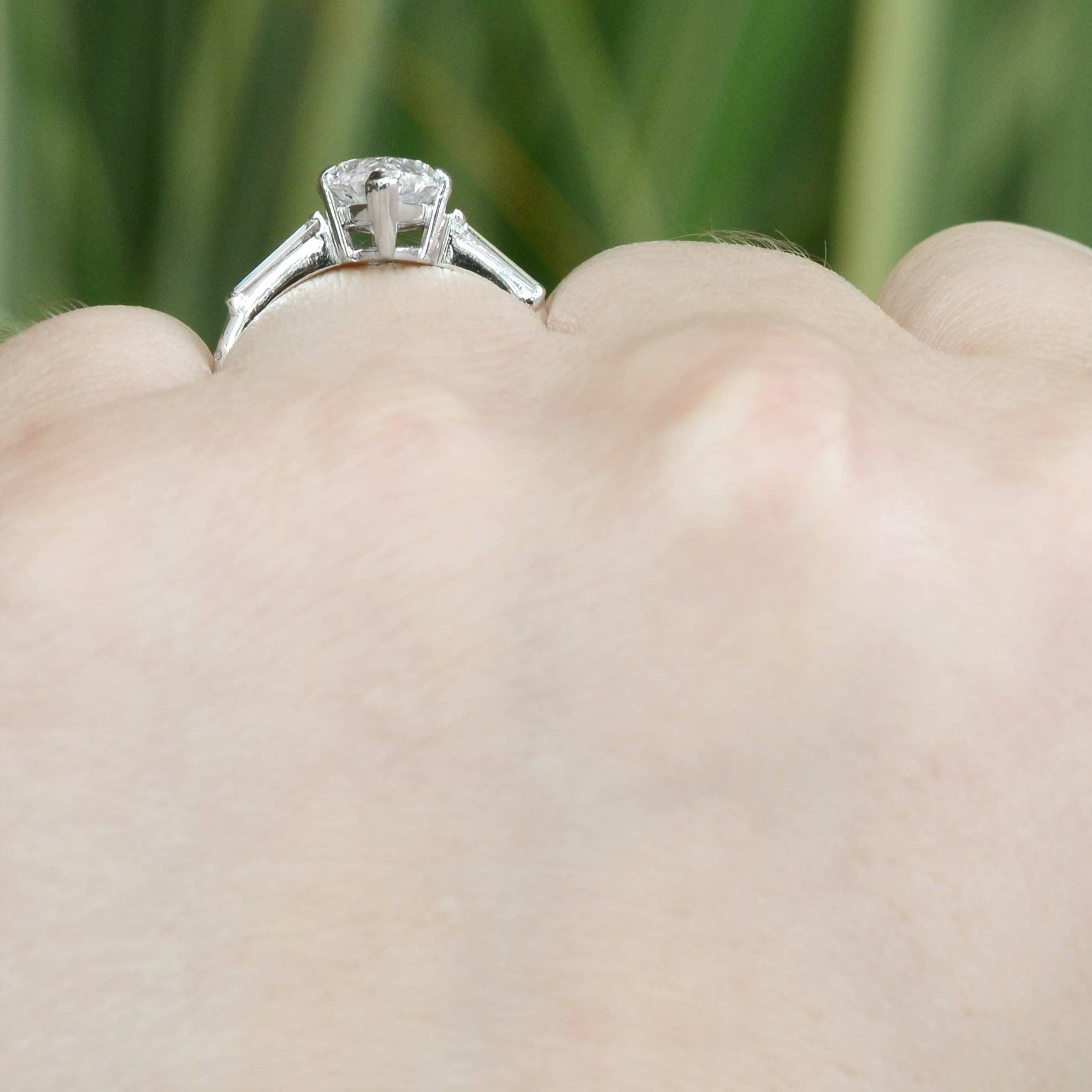 A boat shaped profile, 3 diamond engagement ring.