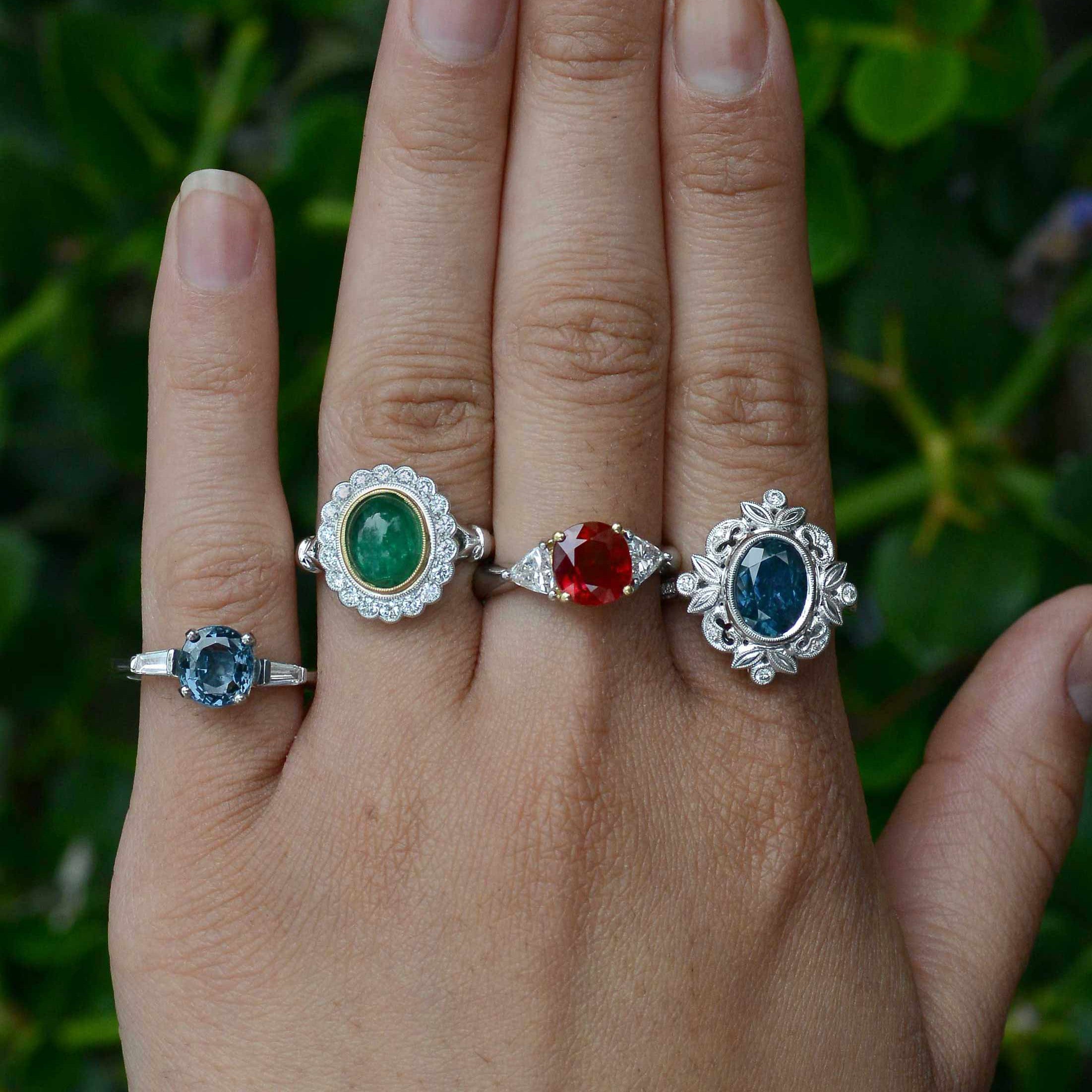 A collection of gem and diamond halo engaggement rings.