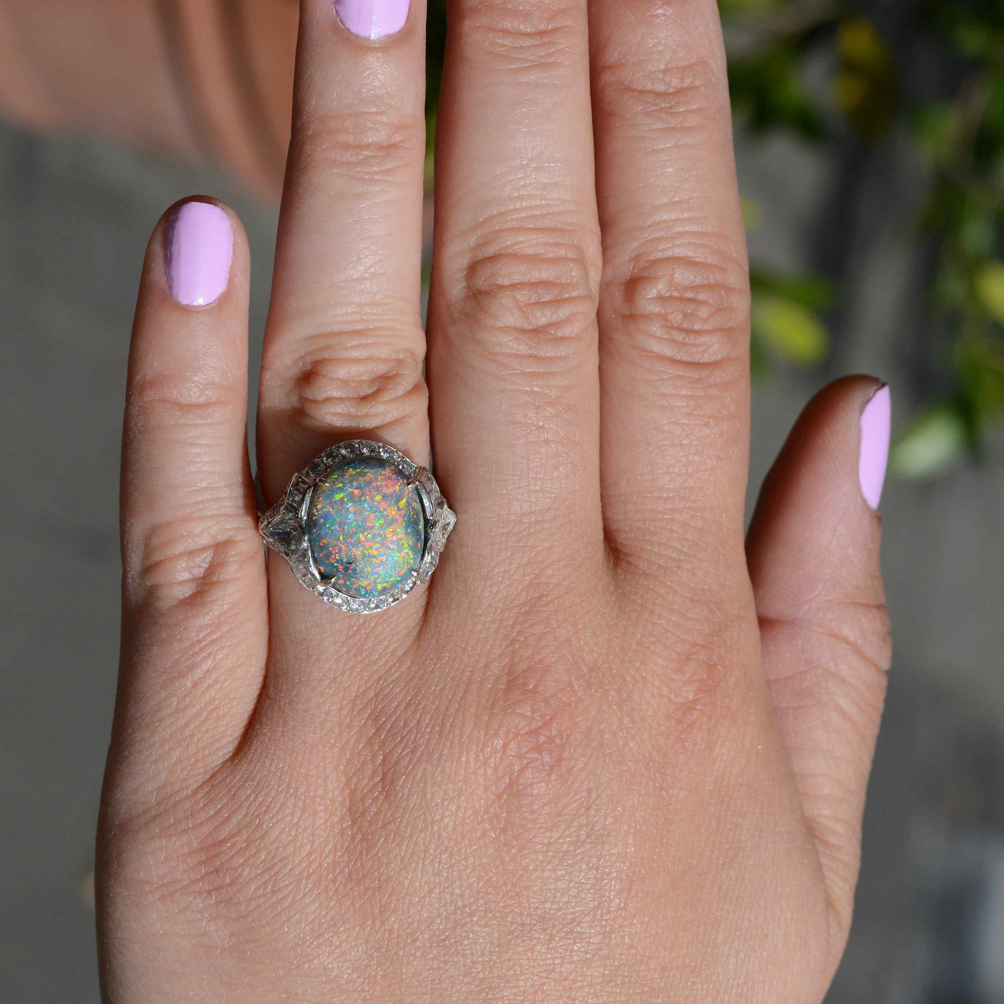 Large oval gemstone cocktail rings with accent diamonds.