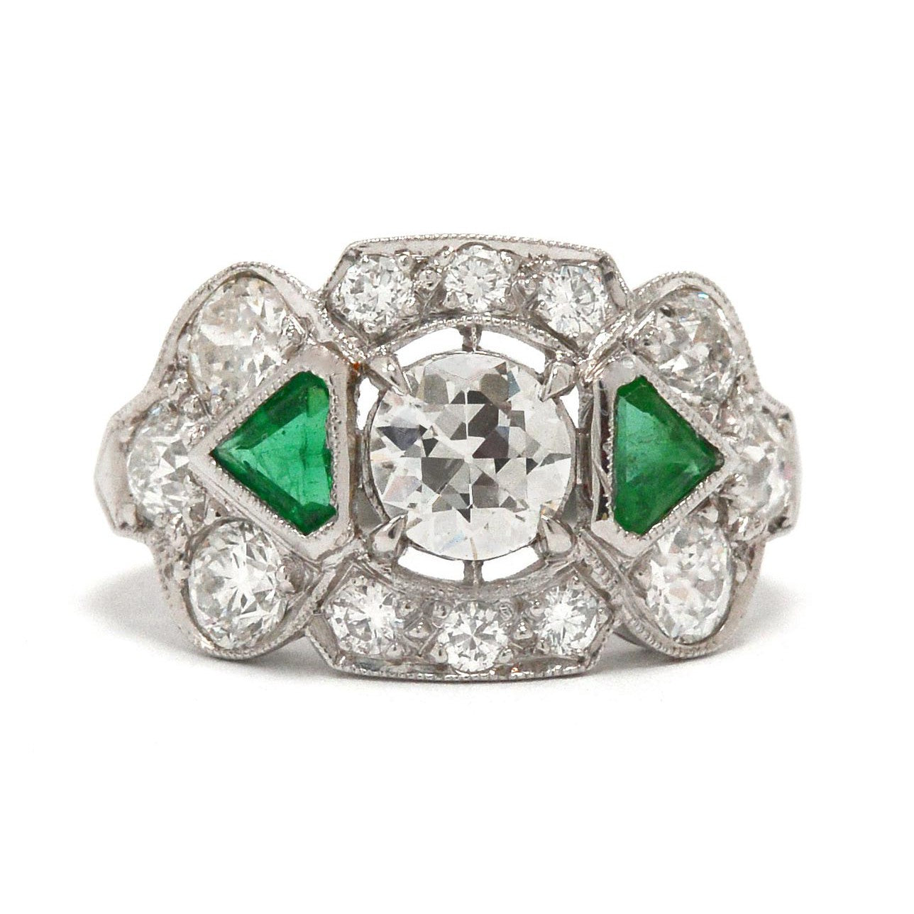 Old European brilliant diamond engagement ring with emeralds.