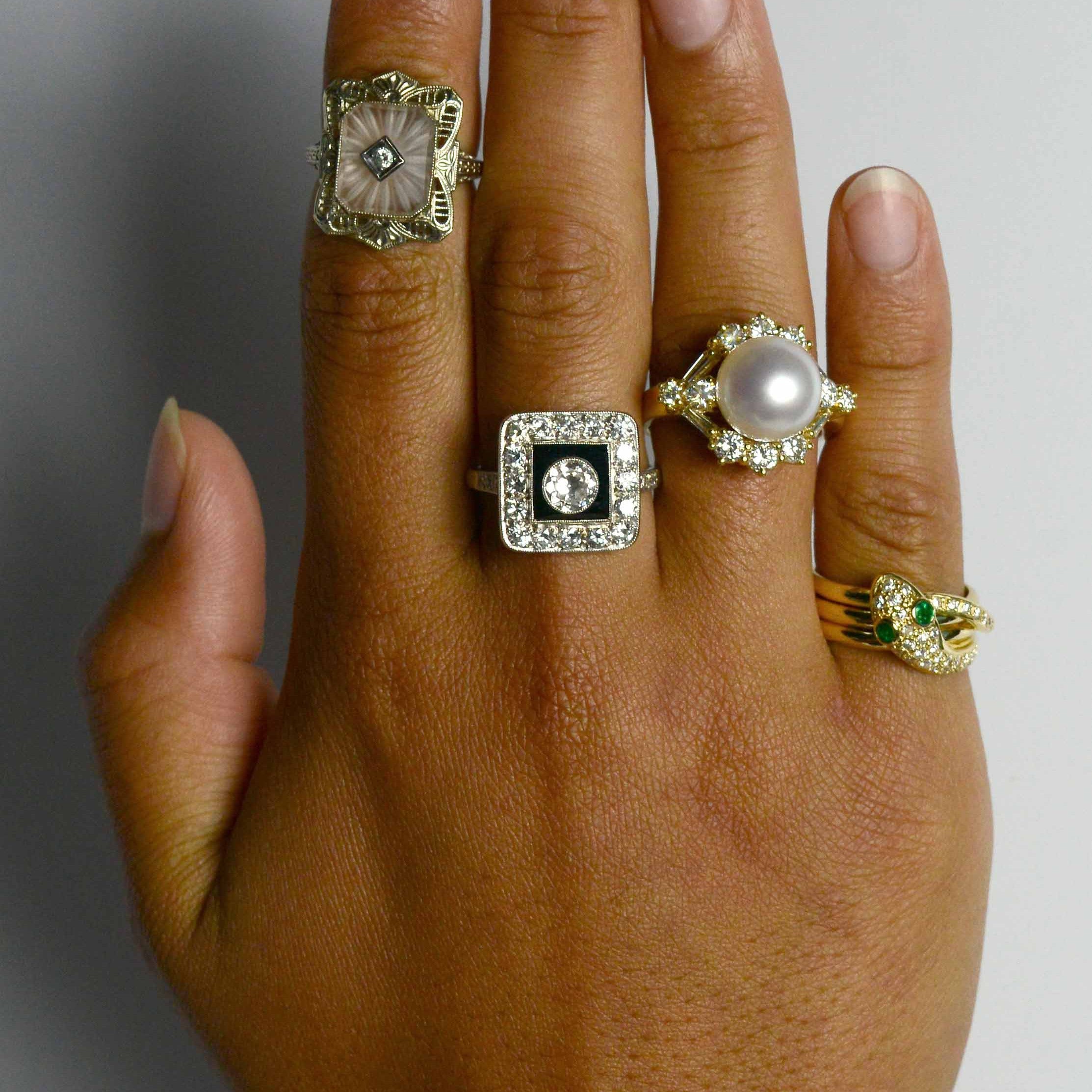 A collection of unique gem and diamond halo statement rings.