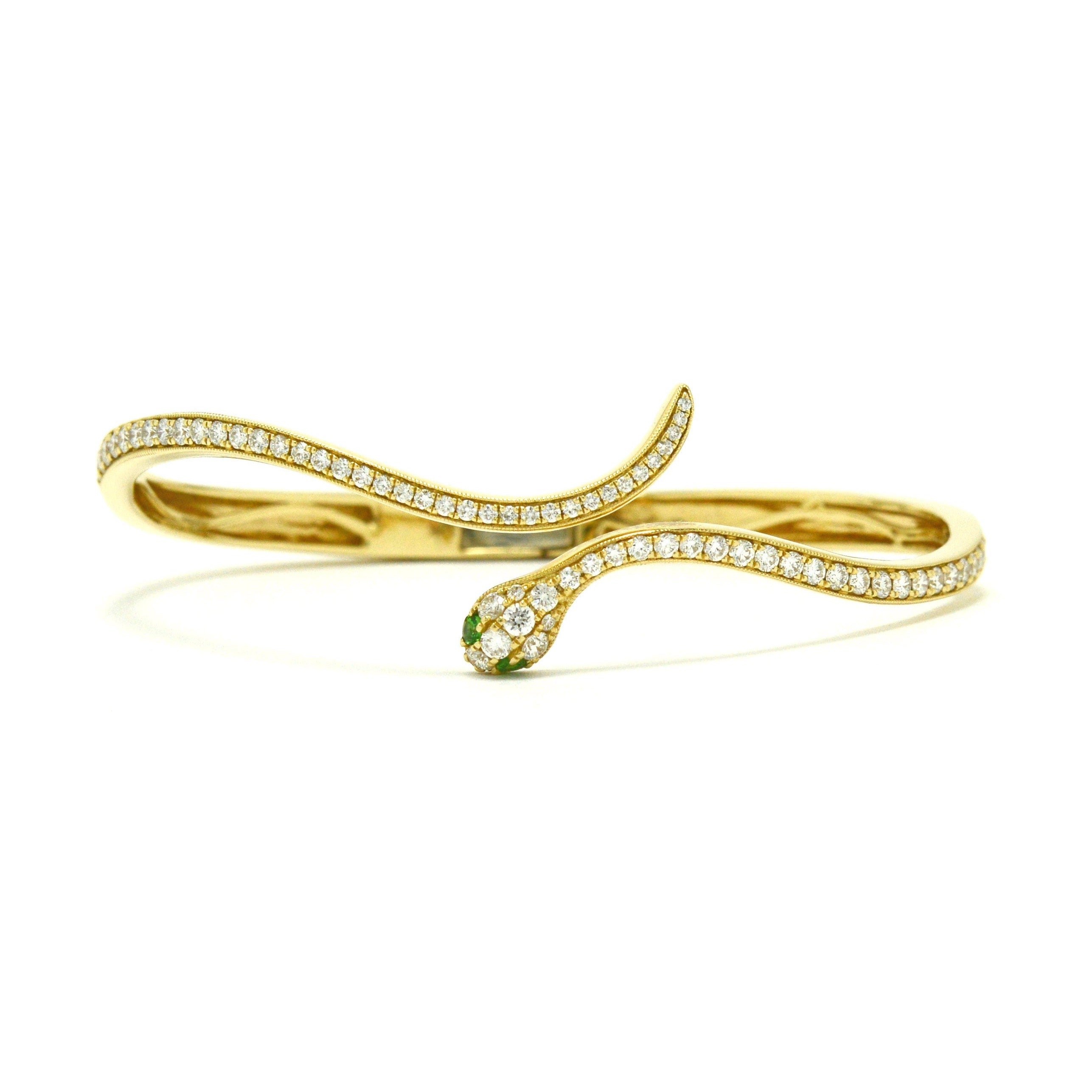 A newly made 14k Egyptian revival snake bangle bracelet with diamonds.