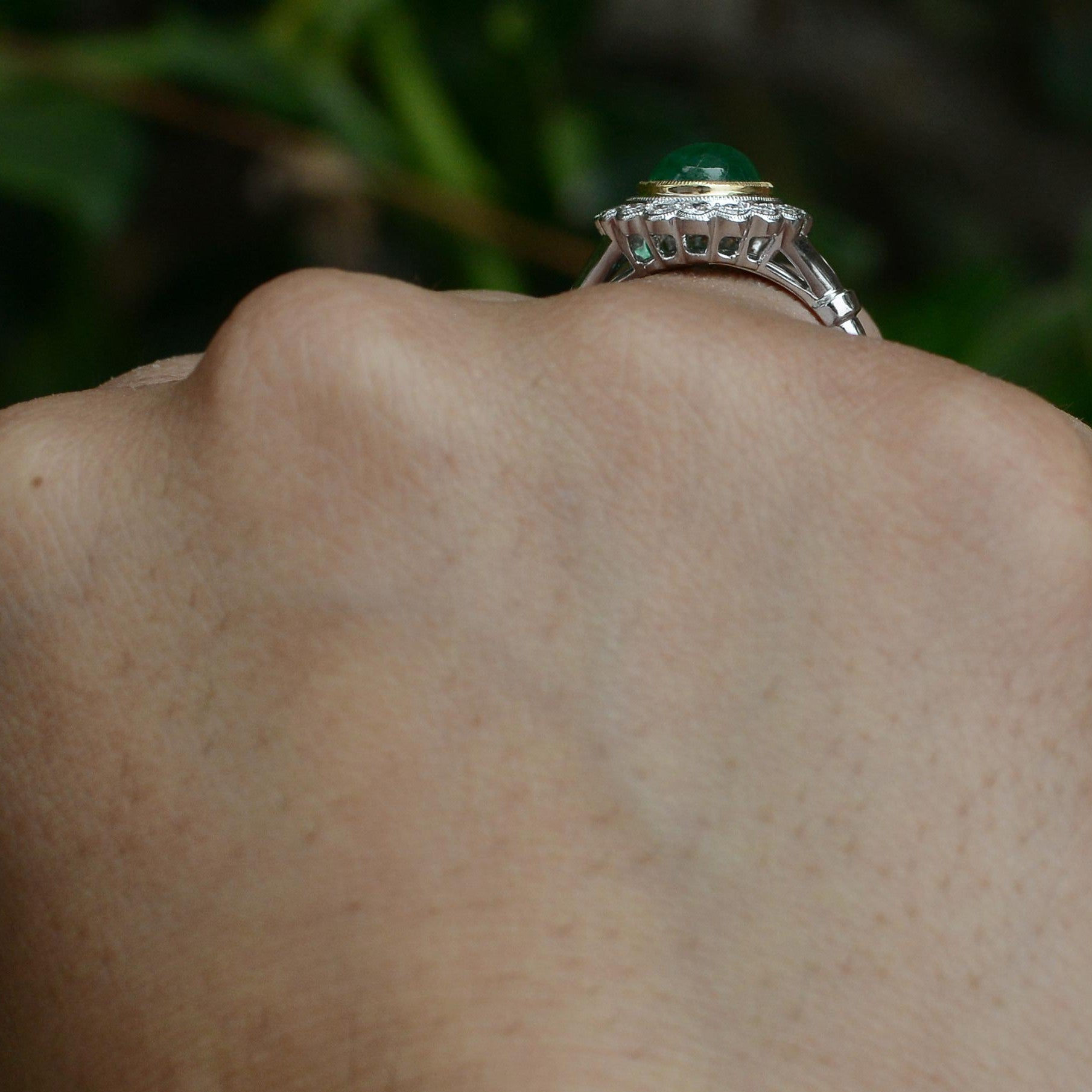 An Edwardian style, emerald cabochon ring with diamonds.