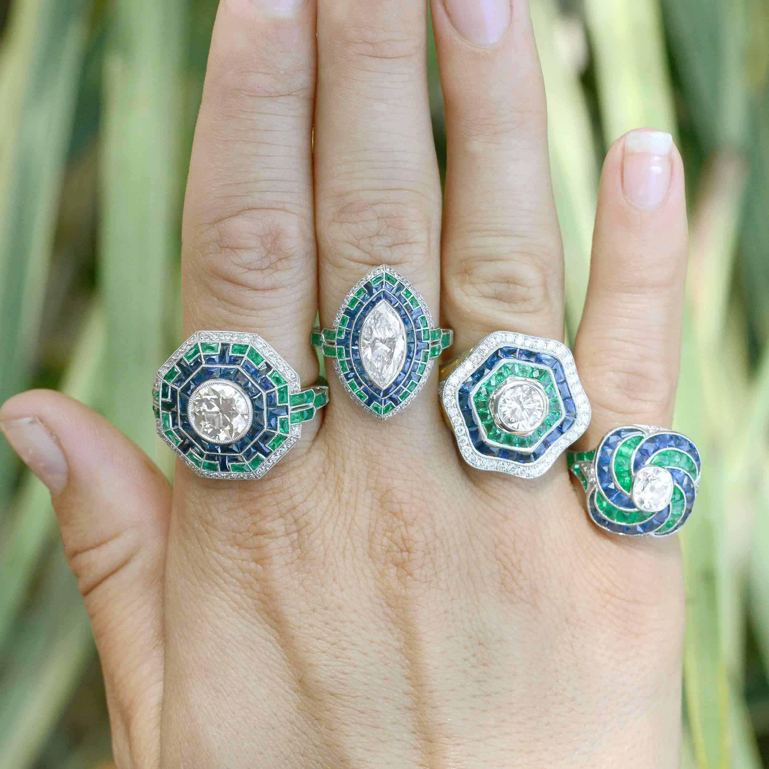 A collection of diamond, emerald and sapphire statement rings.