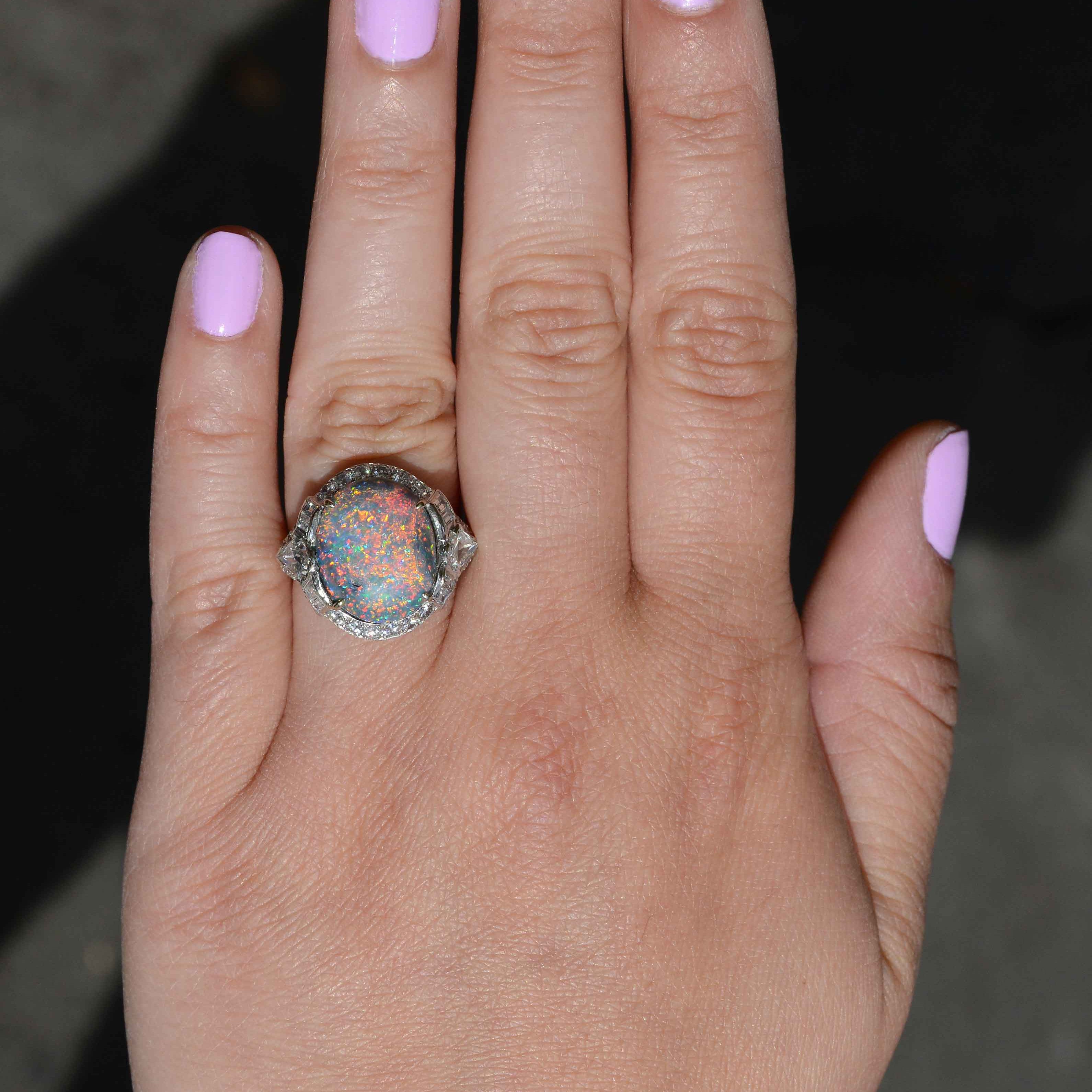 This cabochon dome opal statement ring is accented with a halo of diamonds.