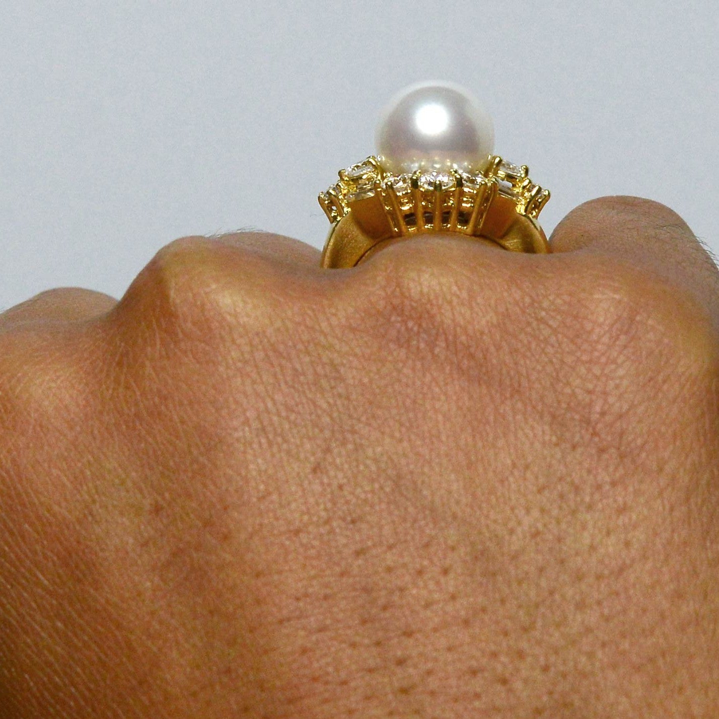 A round natural pearl gold dome cocktail ring.