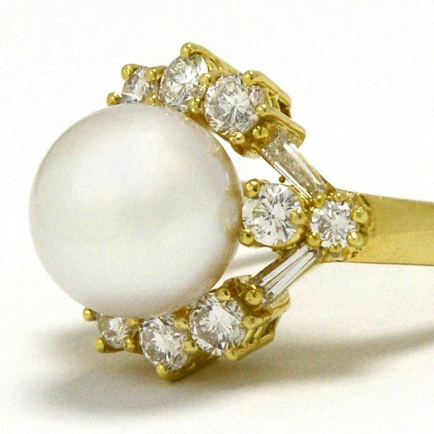 A modern natural pearl dome ring lined with diamonds around.