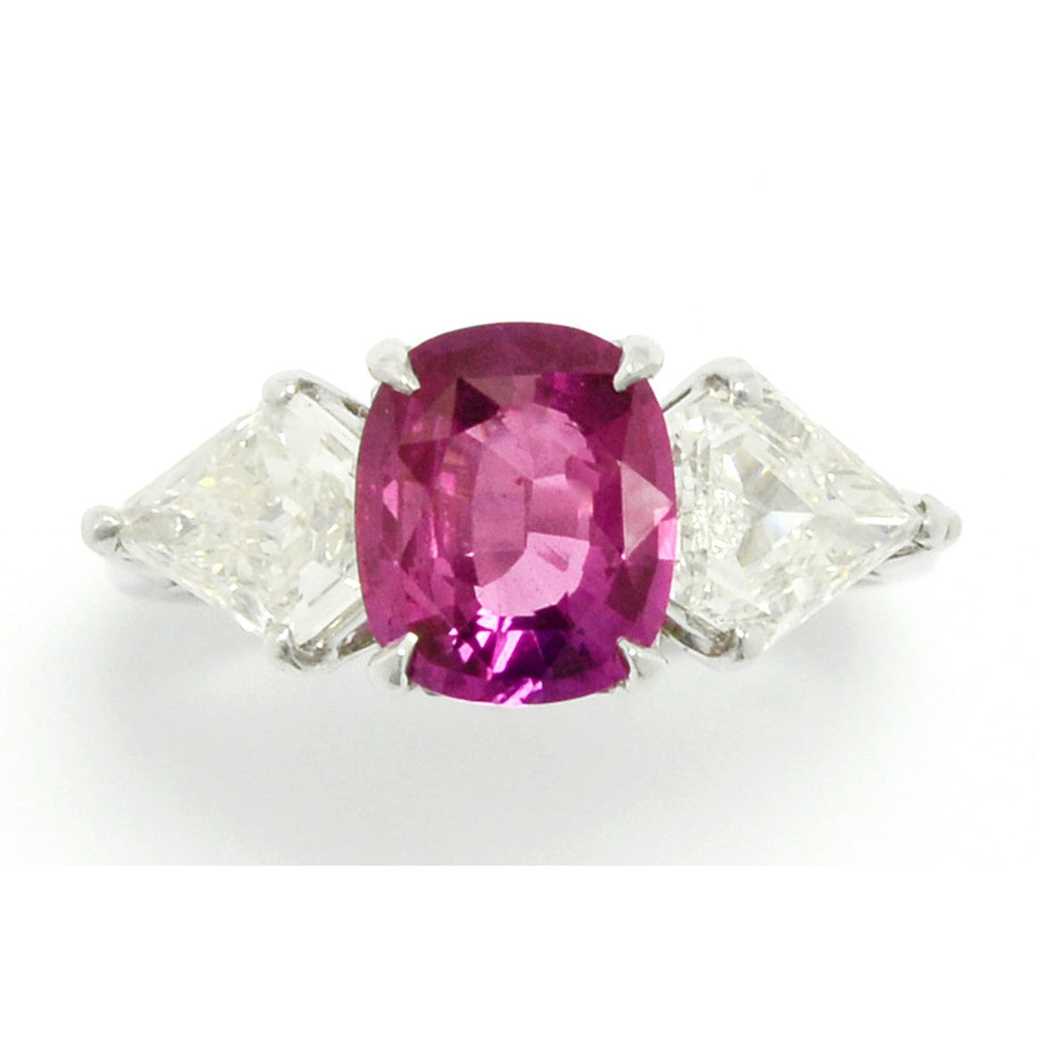 A heated, natural 2 carat cushion cut pink sapphire engagement ring.