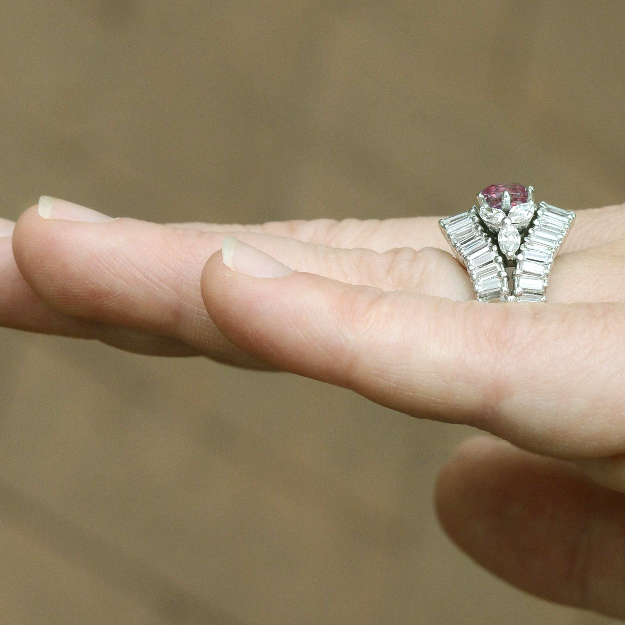 A floral, pink sapphire platinum vintage cocktail ring.