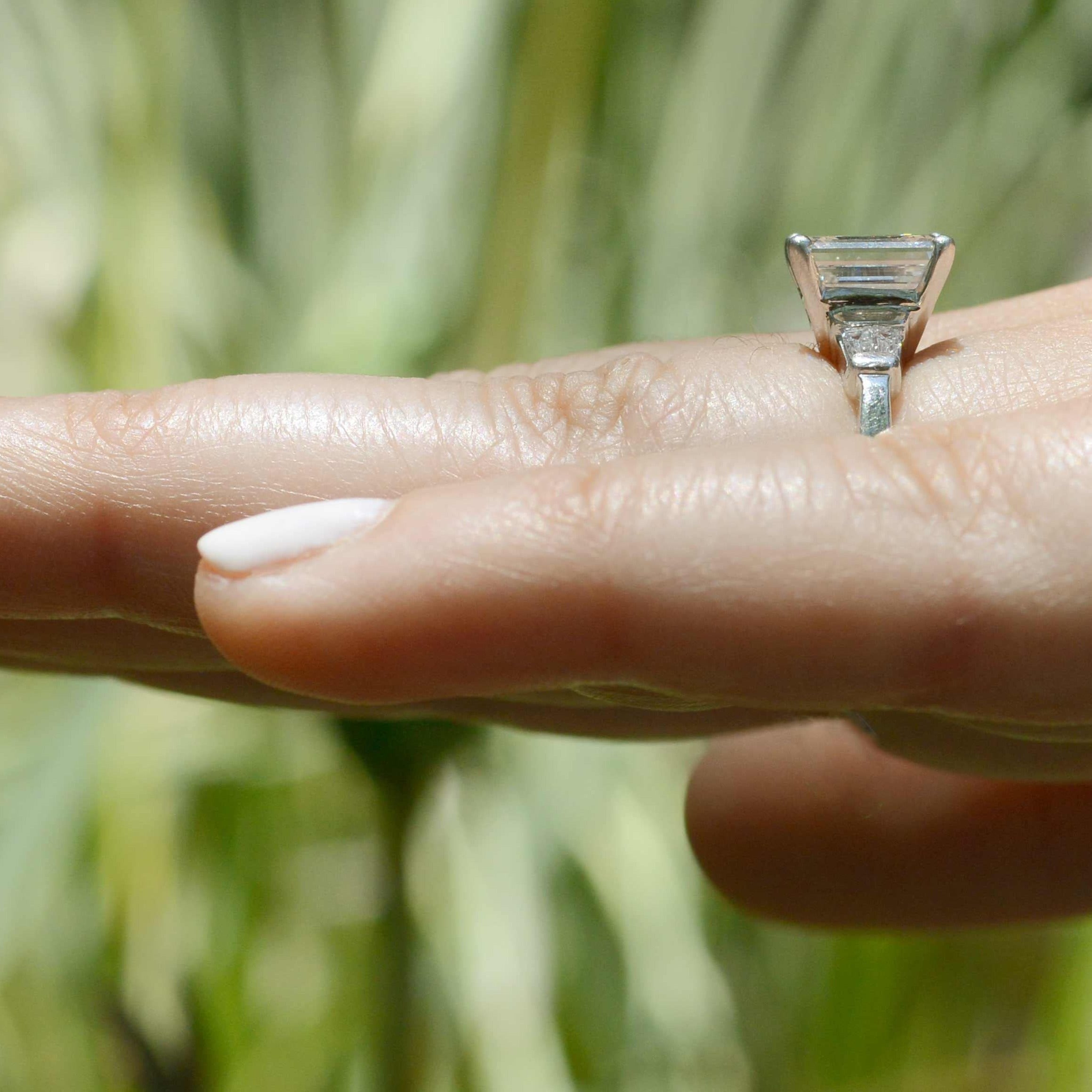 Accompanied by 4 baguette cut diamonds that elevate this platinum solitaire to the next level.