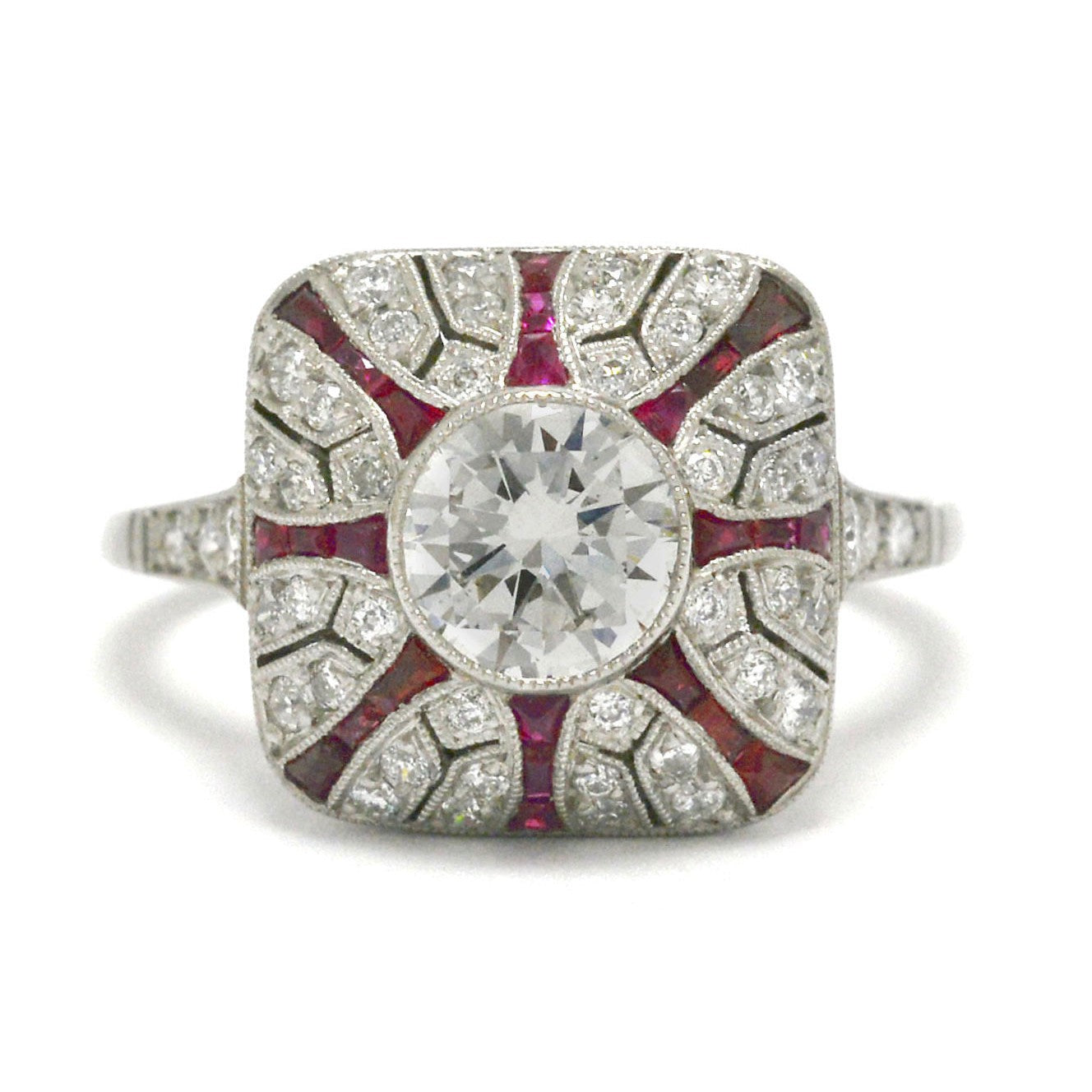 A diamond and ruby starburst platinum Art Deco engagement ring.