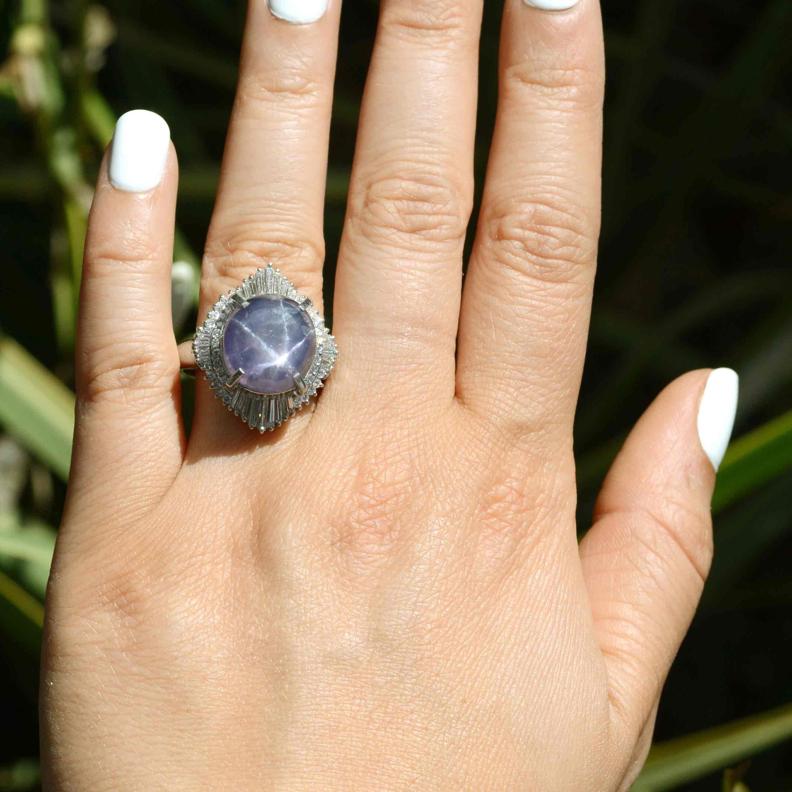 A 6 point star purple sapphire and diamond halo ballerina ring.