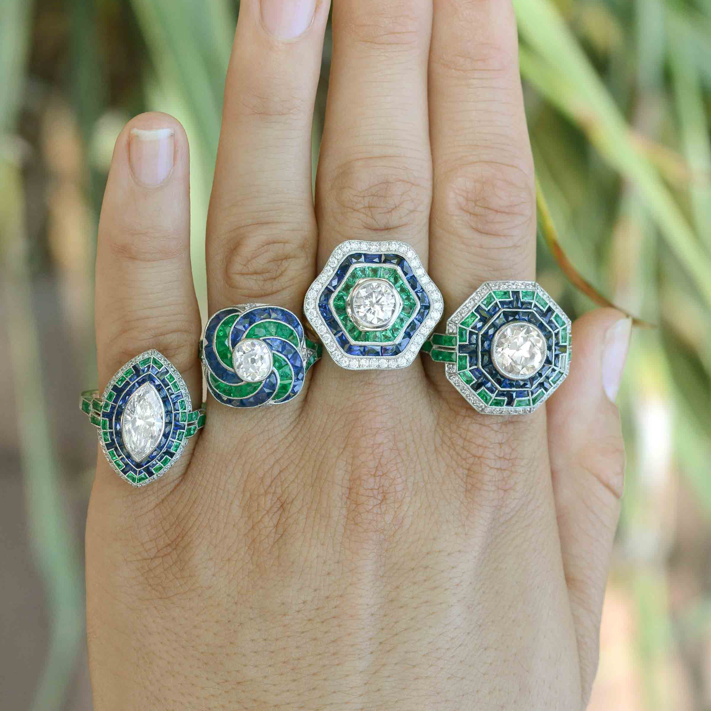 Some of our diamond halo engagement rings with blue sapphire and emerald accents.