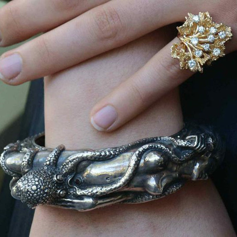 This nude woman silver bracelet design is based on the story, "the dream of the fisherman's wife".