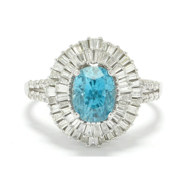 An oval faceted five carat blue zircon statement ring with two halos of diamonds.